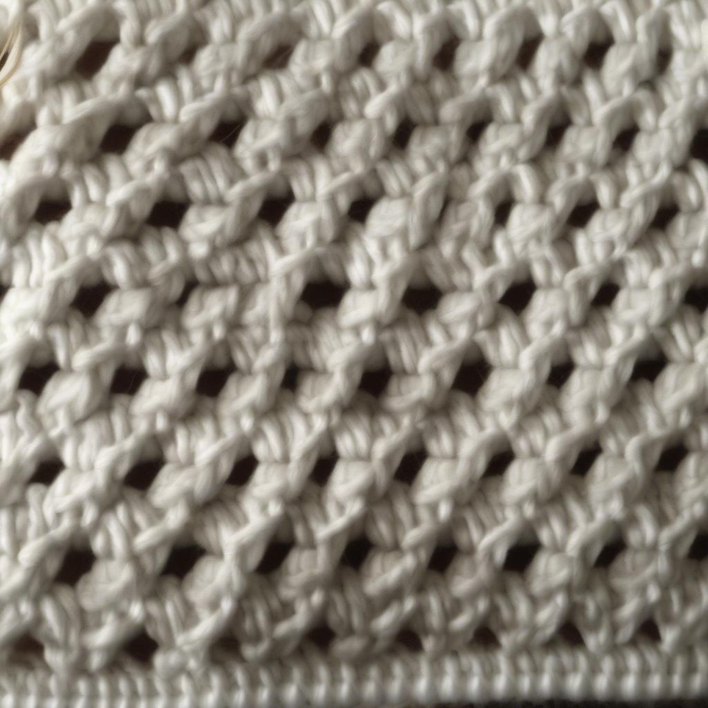 Close-up of a finished basket weave loom knitted hat, showcasing the intricate stitch pattern and soft texture of the yarn.