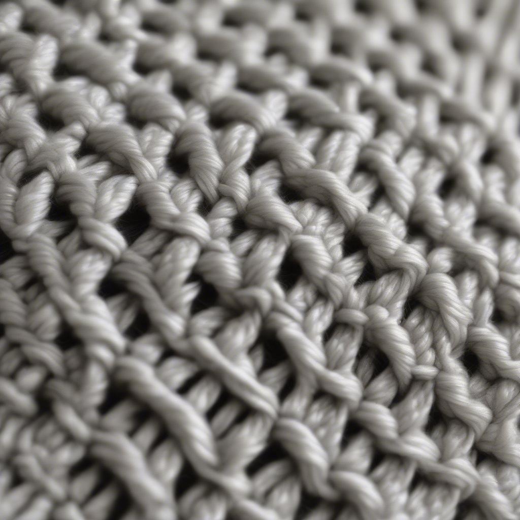 Close-up of the basket weave crochet stitch, showing the alternating single and double crochet stitches that create the textured, woven effect.