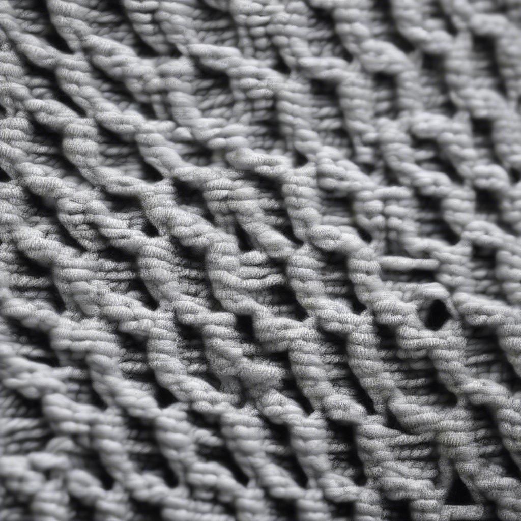 Close-up view of the basket weave stitch showing the knit and purl blocks creating a checkerboard pattern