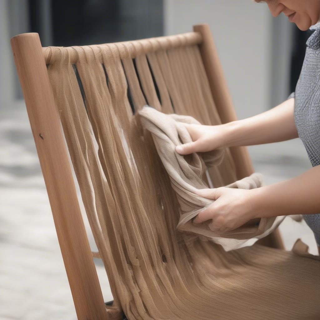 Cleaning a woven outdoor chair with mild detergent and water.