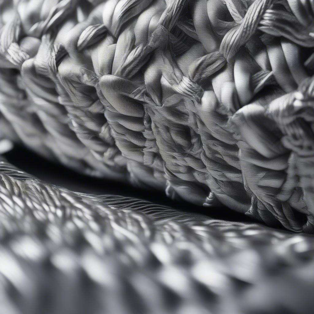 Close-up view of the intricate silver weave of a Chanel bag