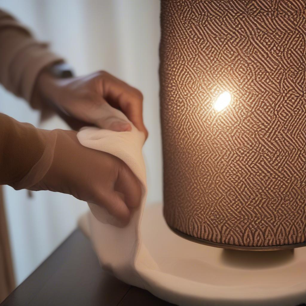 Cleaning a Moroccan Weave Metal Table Lamp with a soft, dry cloth to maintain its shine and beauty.