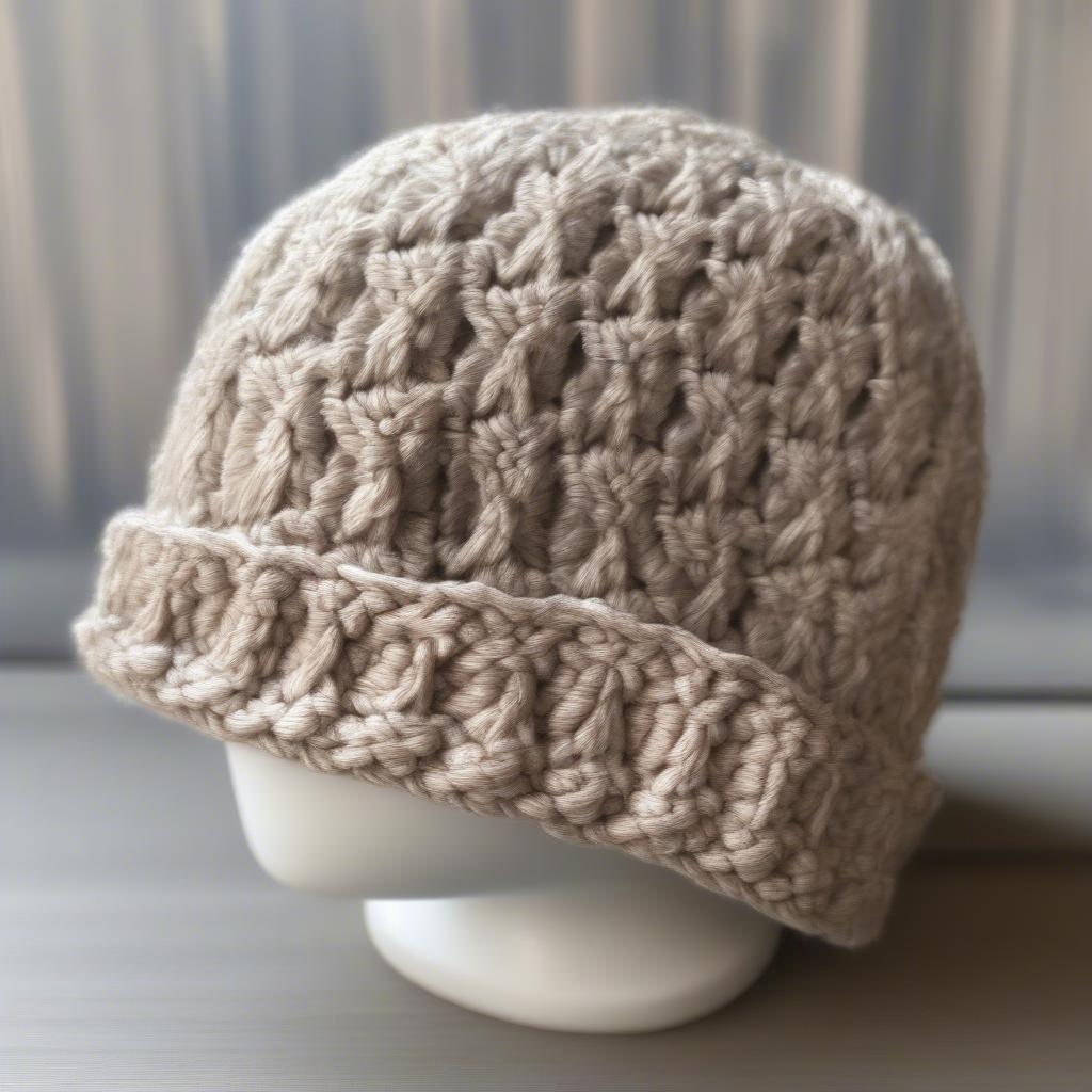 A close-up photo of a finished open weave crochet hat, showcasing the beautiful stitchwork and texture.