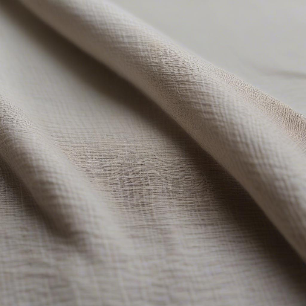 Close-up of a handwoven linen tablecloth showing intricate weave detail