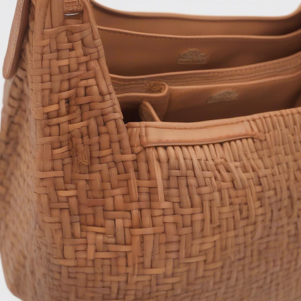 Close-up view of The Sak Emma woven shoulder bag showcasing its intricate woven pattern and natural fiber texture.