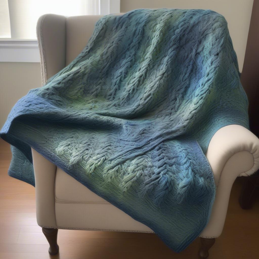 Image of a finished basket weave crochet blanket with an intricate cable design.