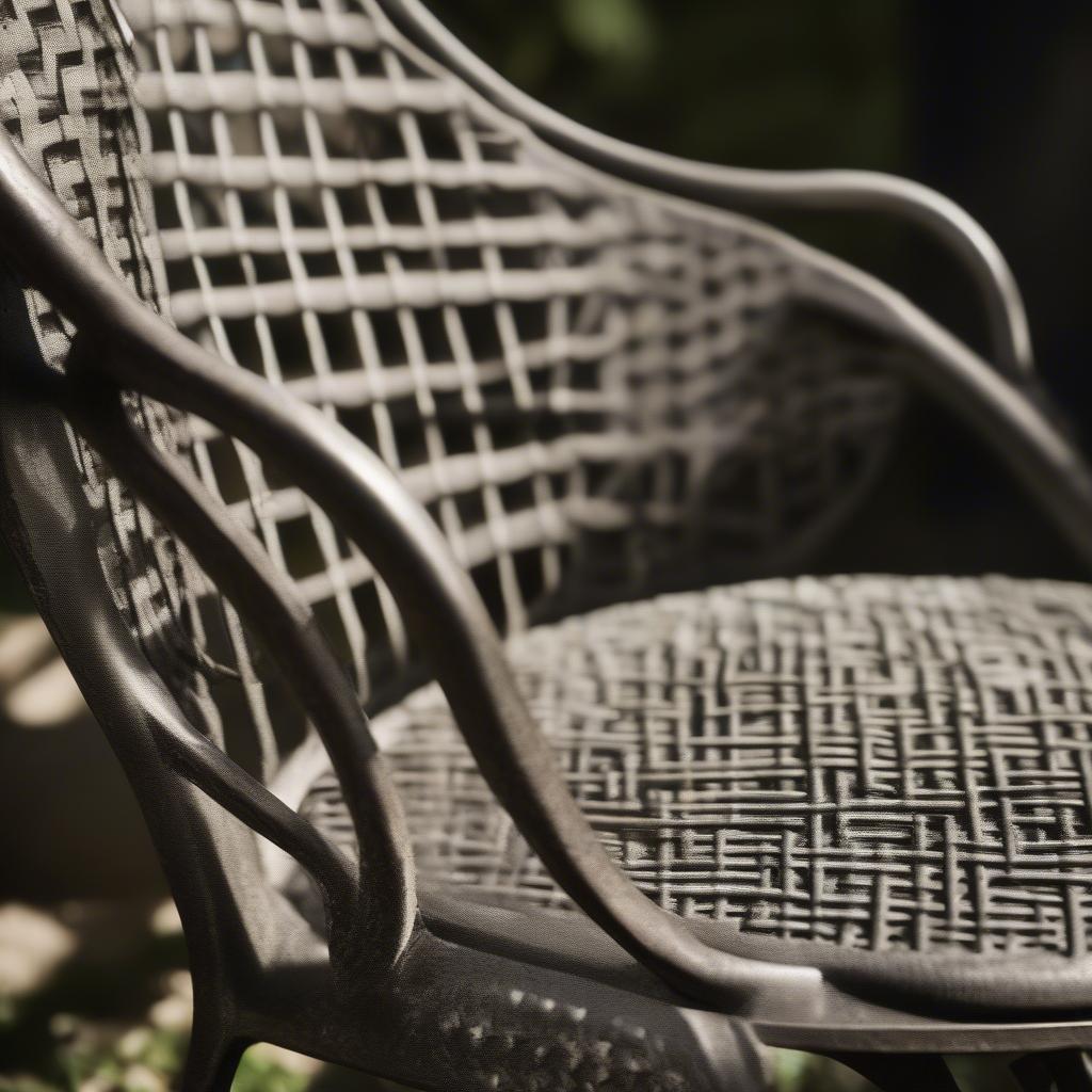 Close-up of the intricate basket weave pattern on an antique metal lawn chair