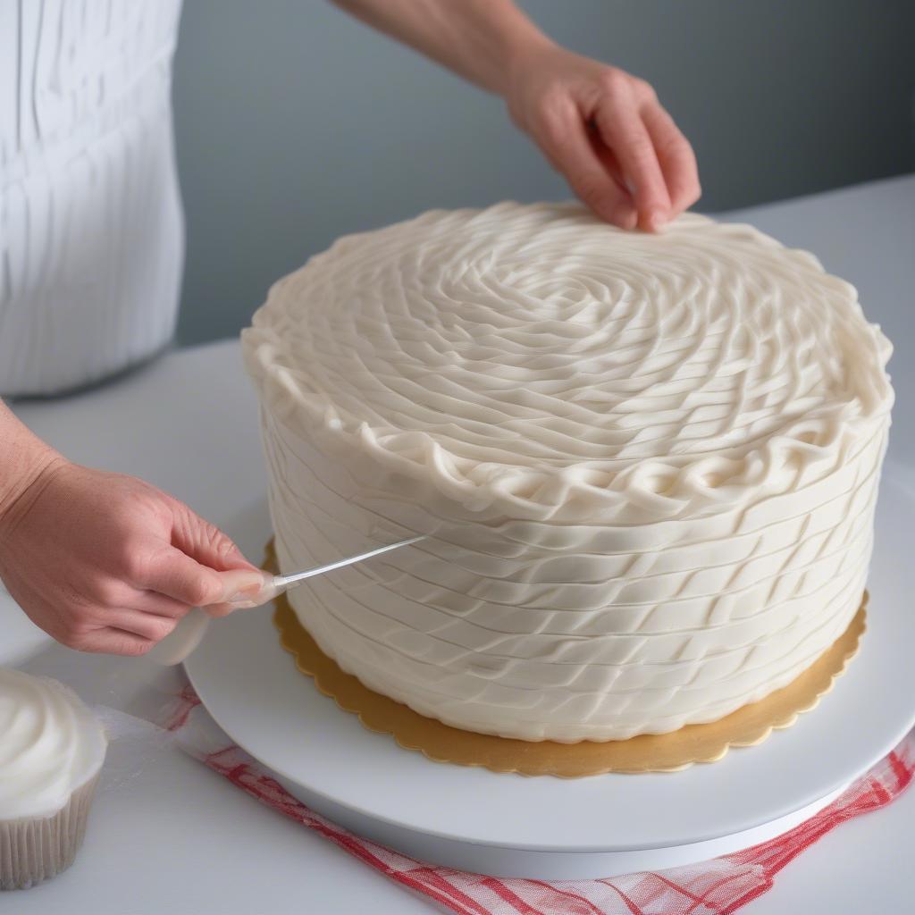 A baker demonstrating the basket weave icing technique on a cake.