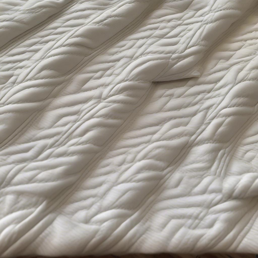 Close-up of a finished basket weave baby quilt showing the intricate texture and stitching.