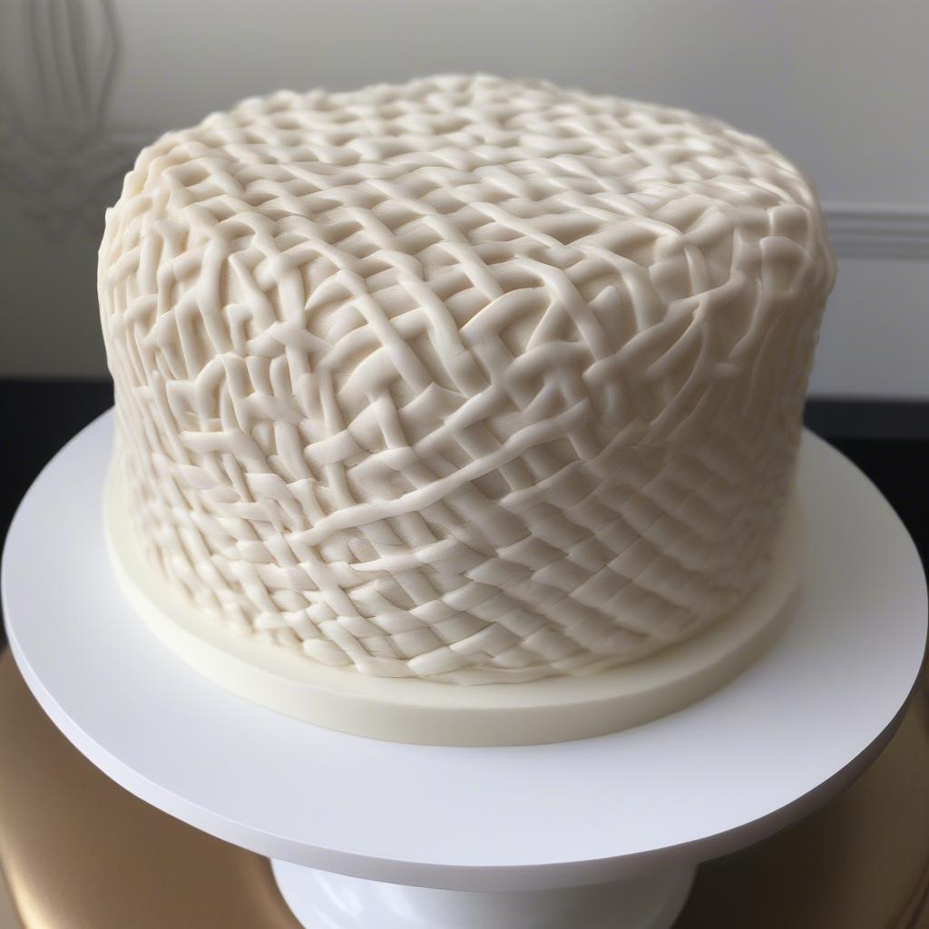 Close up of a cake decorated with a basket weave pattern