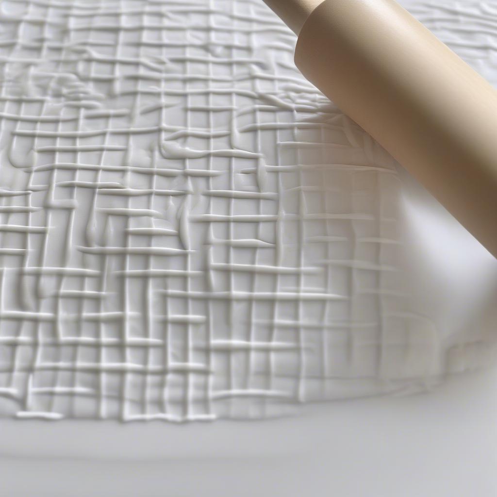 Rolling pin creating basket weave pattern on fondant