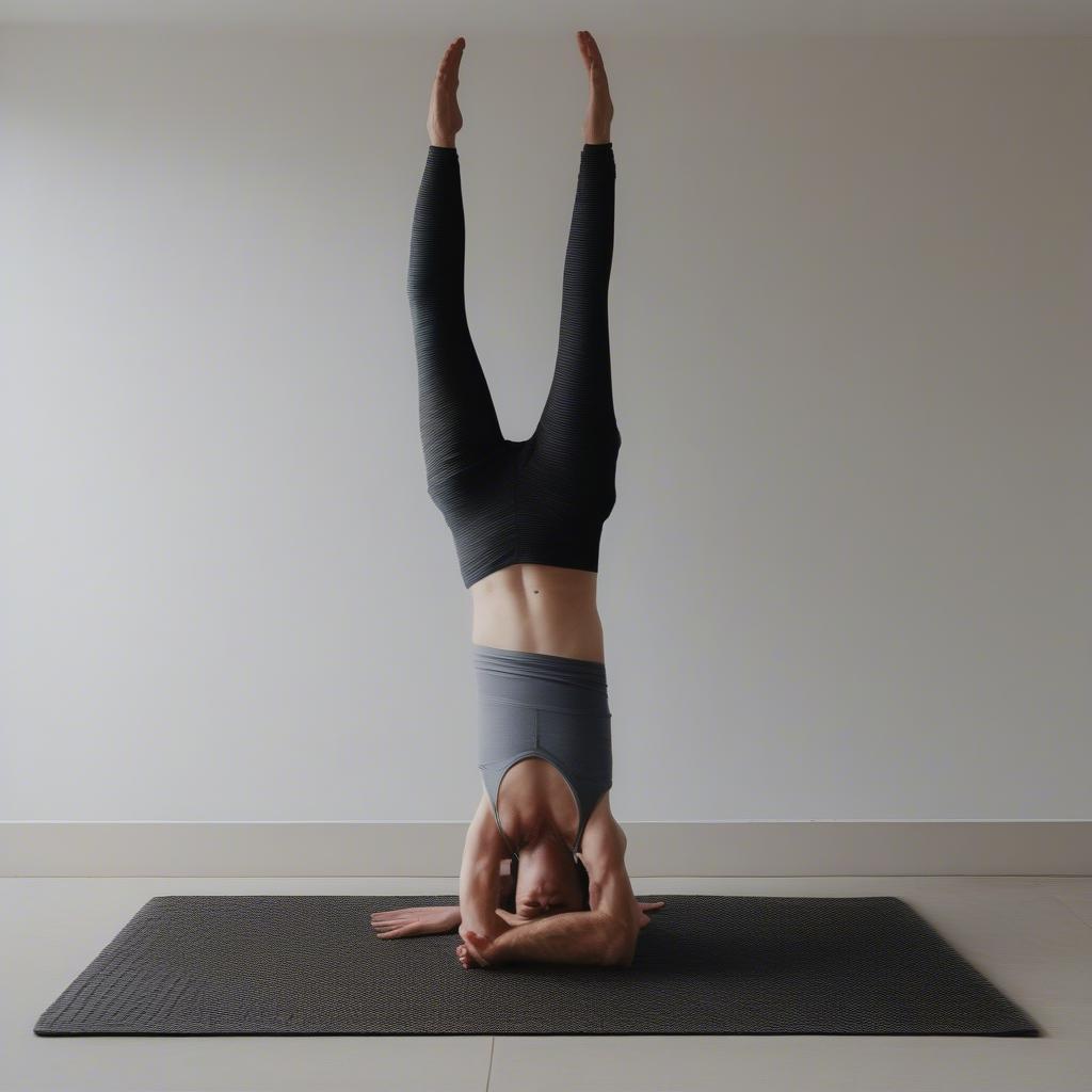 Beginner practicing the Basket Weave Headstand Pose