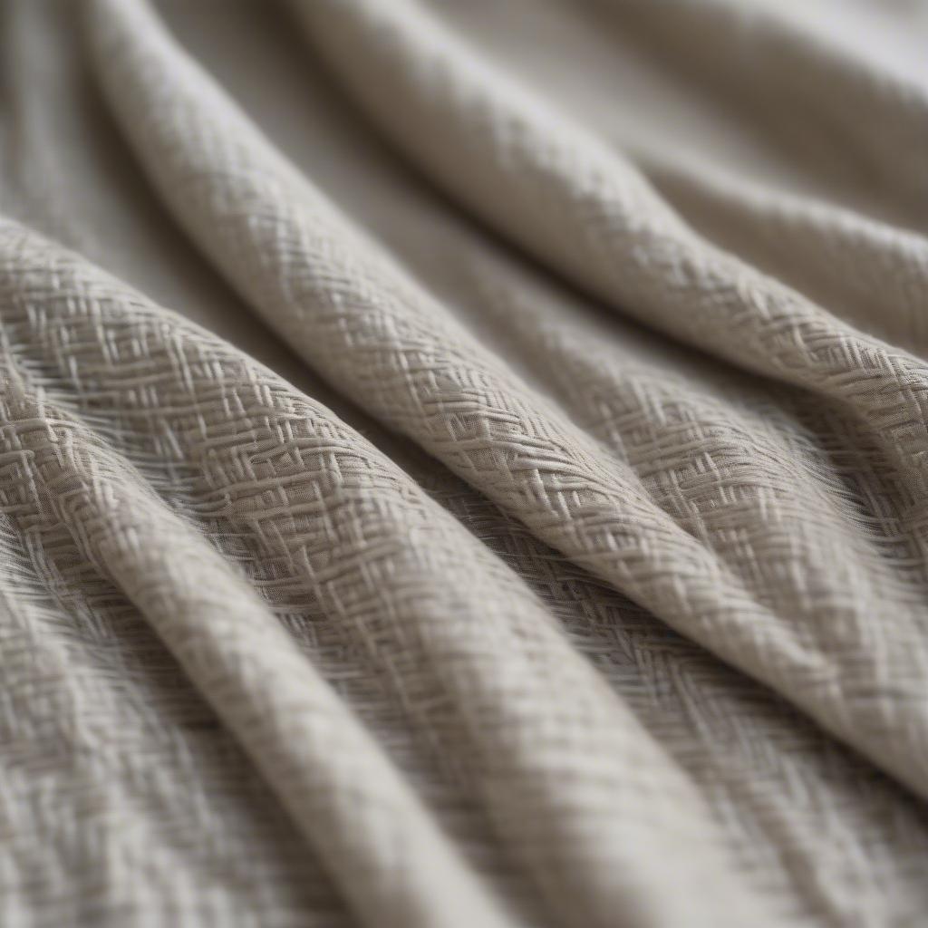 Close-up view of basket weave linen drapery showcasing the intricate woven pattern and the natural texture of the linen fabric.