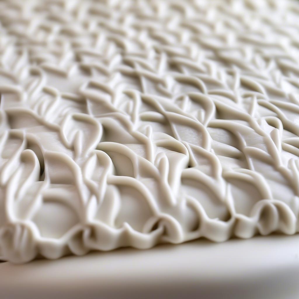 Close-up of a basket weave pattern created with royal icing on a cake