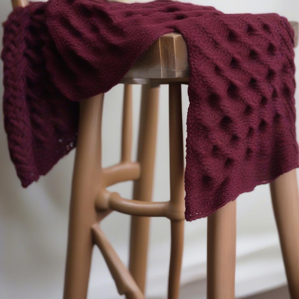 A finished basket weave scarf draped over a chair