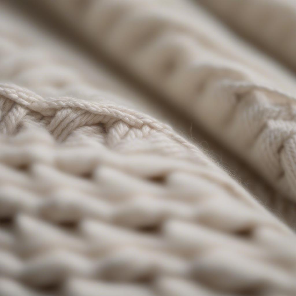 Close-up view of the basket weave stitch in a knitted blanket