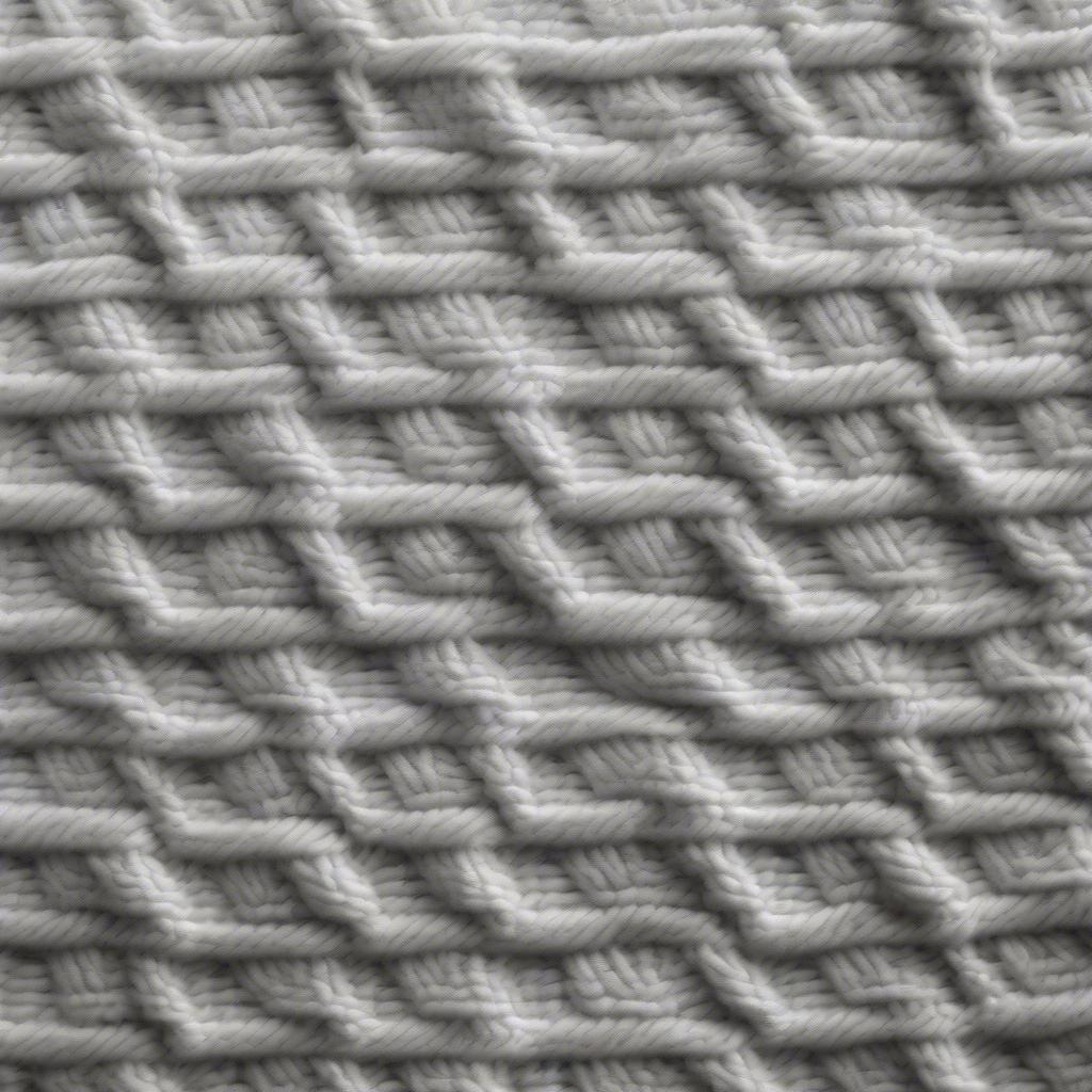 Close-up view of the basket weave stitch showing the alternating knit and purl blocks