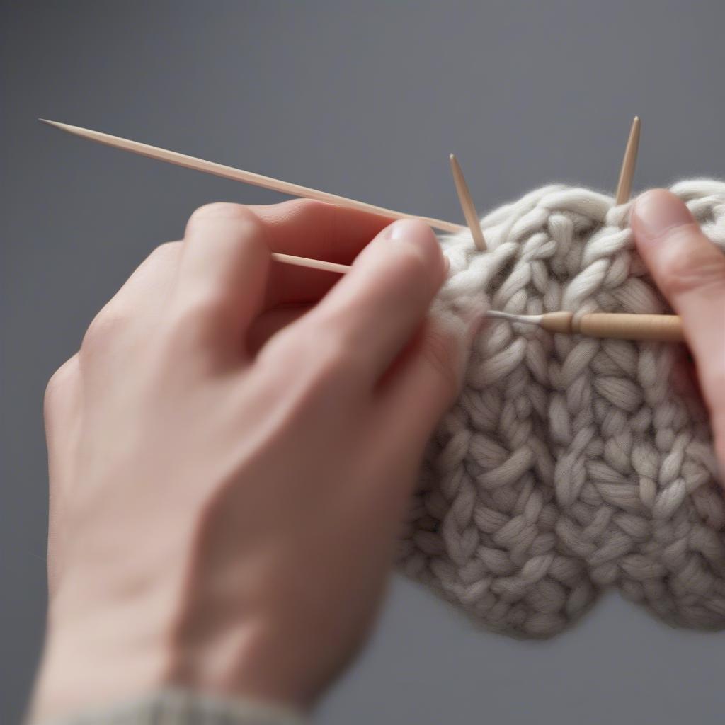 Close-up of hands creating the basket weave stitch