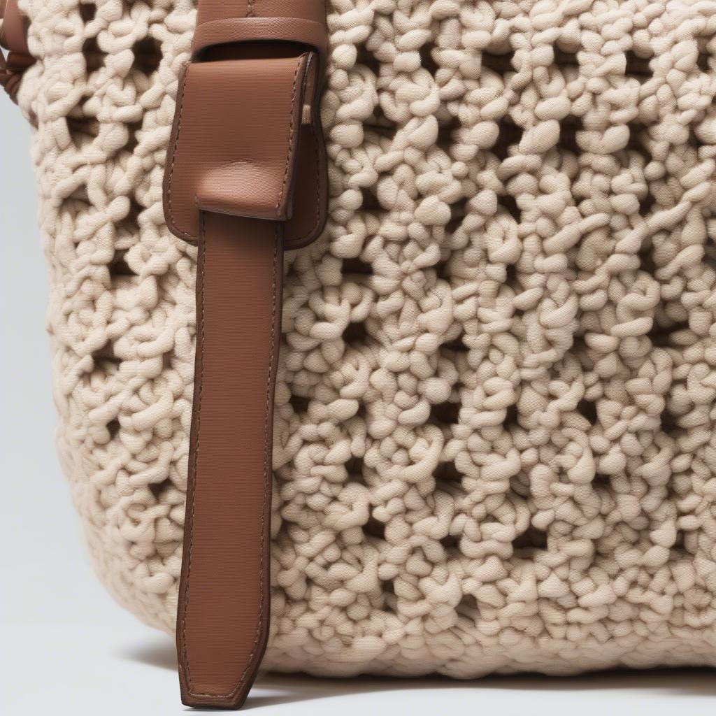 Close-up view of the intricate crochet pattern on a BCBG Max Azria bag