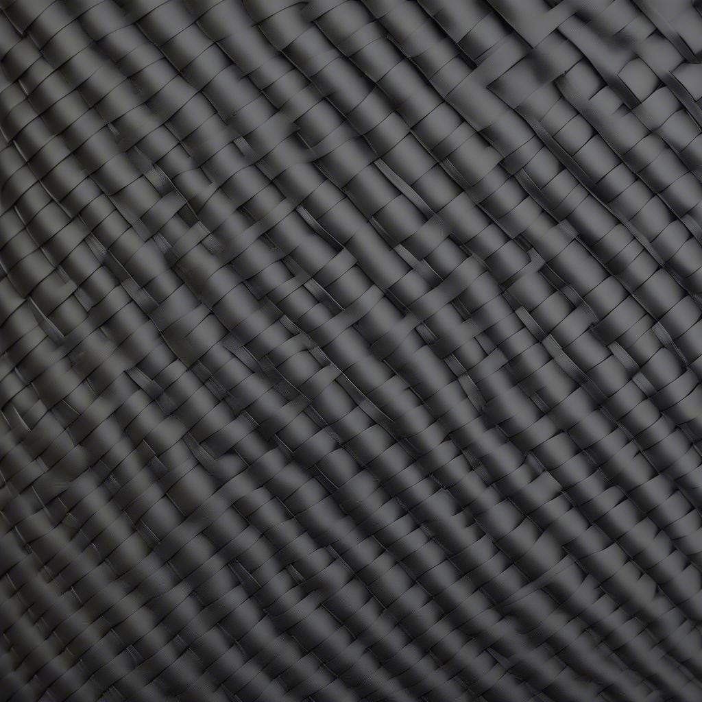 A sheet of black basket weave kydex showcasing the texture and pattern