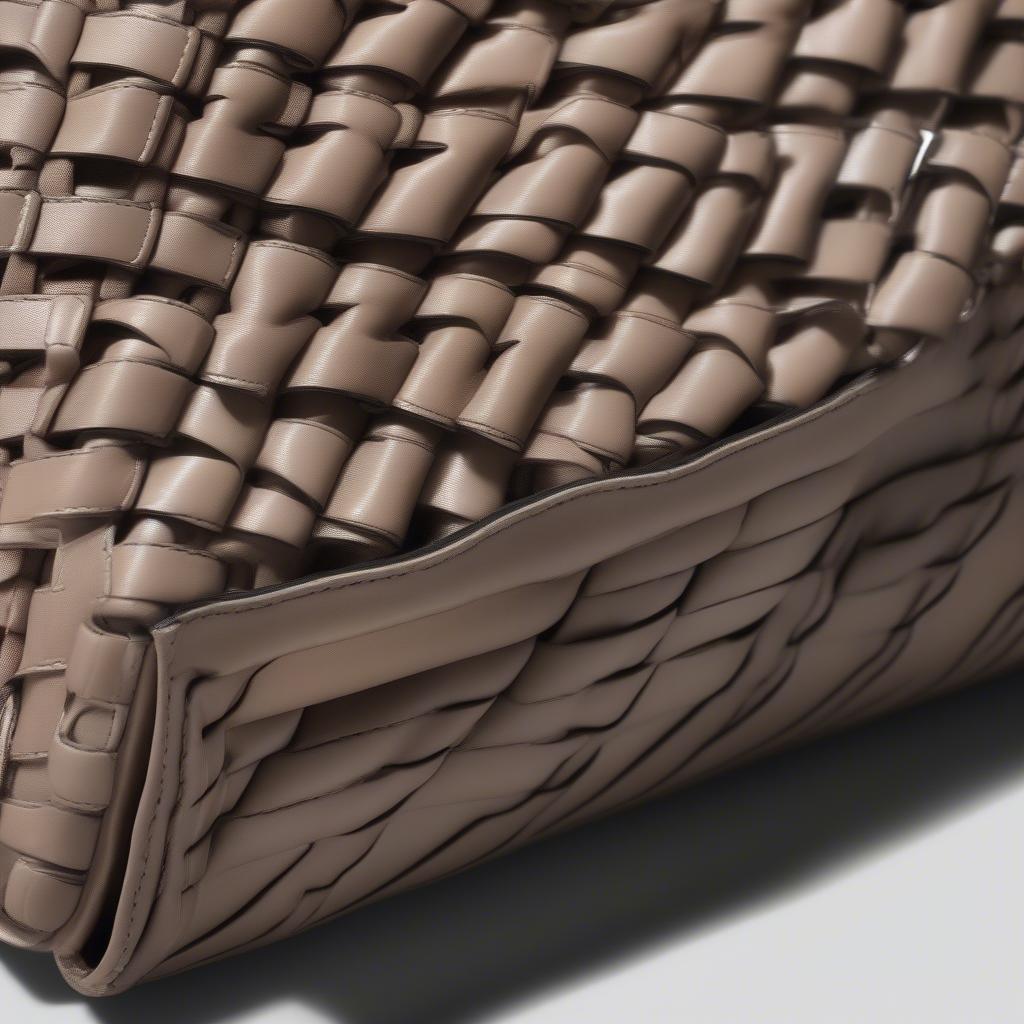 Close-up view of the Bottega Veneta Intrecciato weave on a chain linked shoulder bag