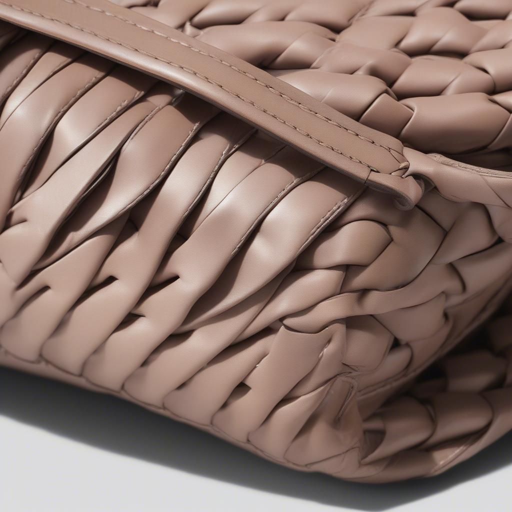 Close-up view of the Bottega Veneta Mini Woven Shoulder Bag showcasing the Intrecciato weave.