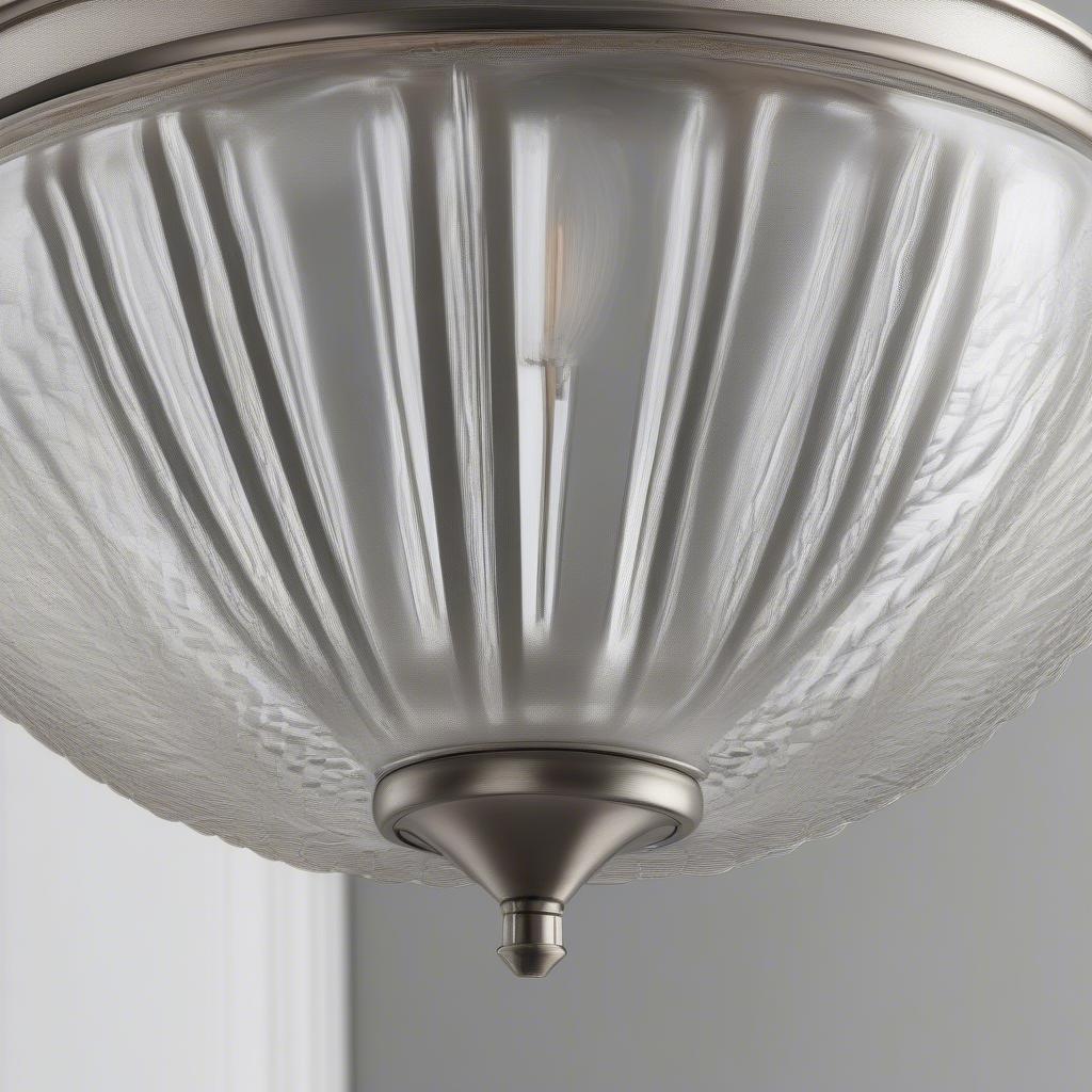 Close-up view of the Brinton vanity light's clear basket weave shade