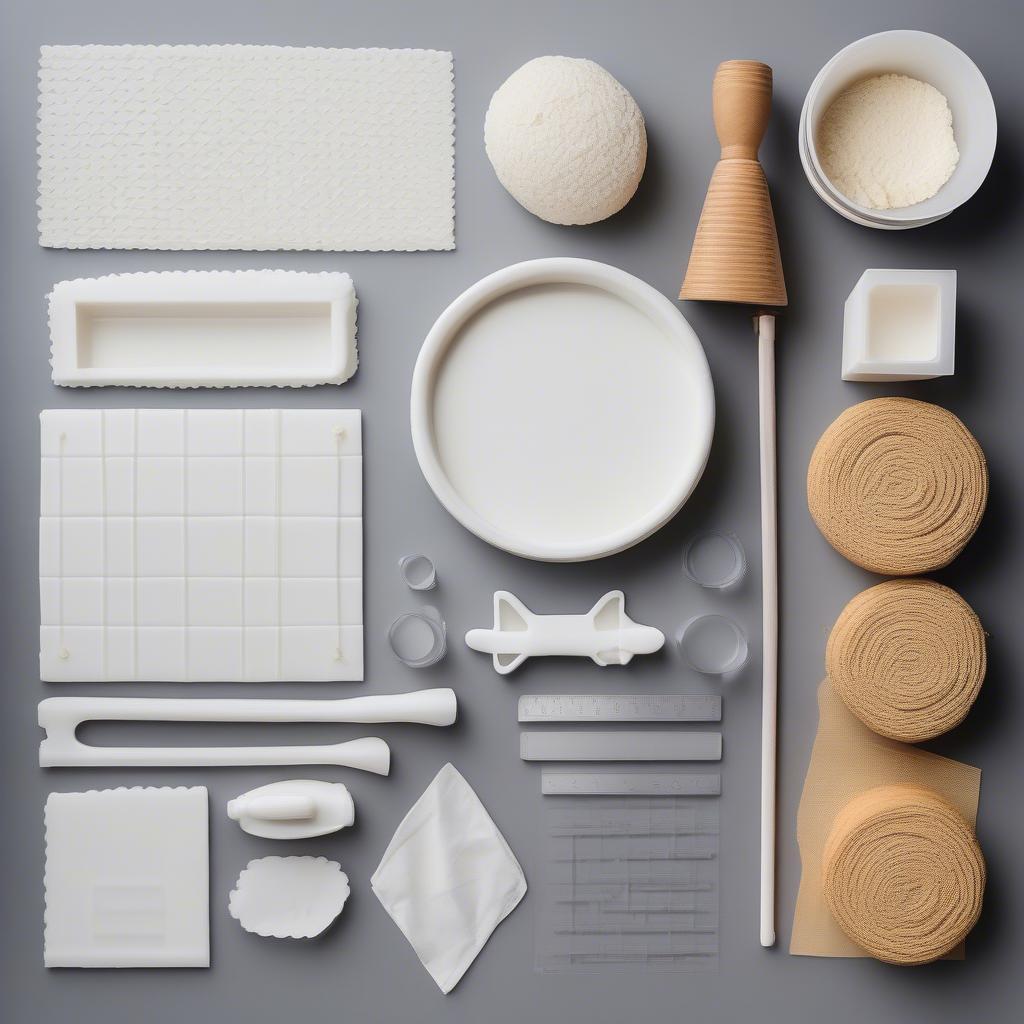 Essential cake decorating tools for creating a basket weave border, including a piping bag, piping tips, and a bench scraper.