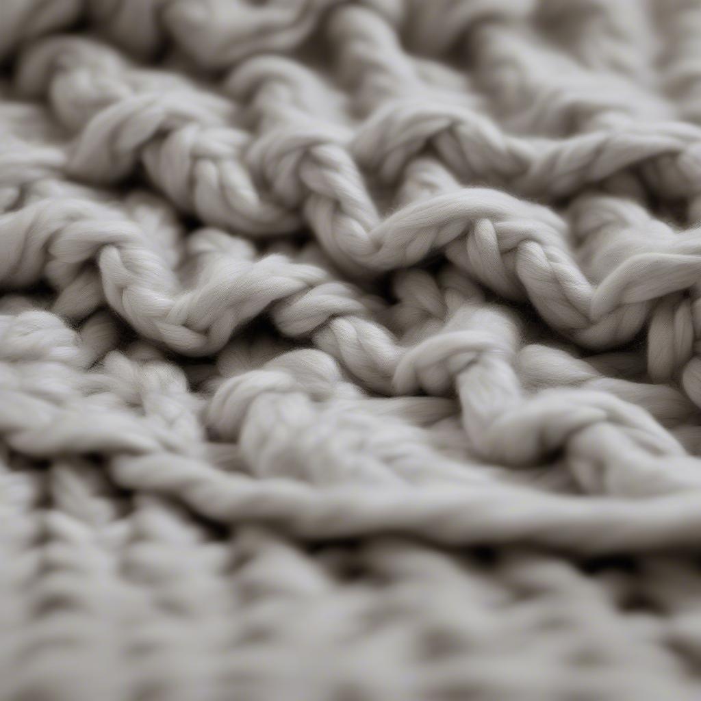 Close up of a basket weave blanket hanging on a properly sized hook, demonstrating secure hanging and visual appeal.