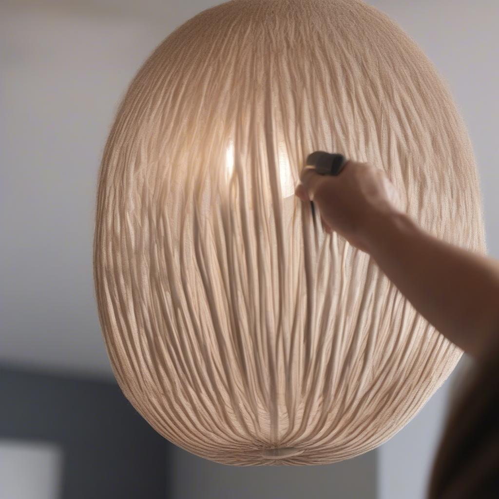 Cleaning a Basket Weave Pendant Light: A close-up shot of a hand gently dusting a basket weave pendant light with a soft brush.