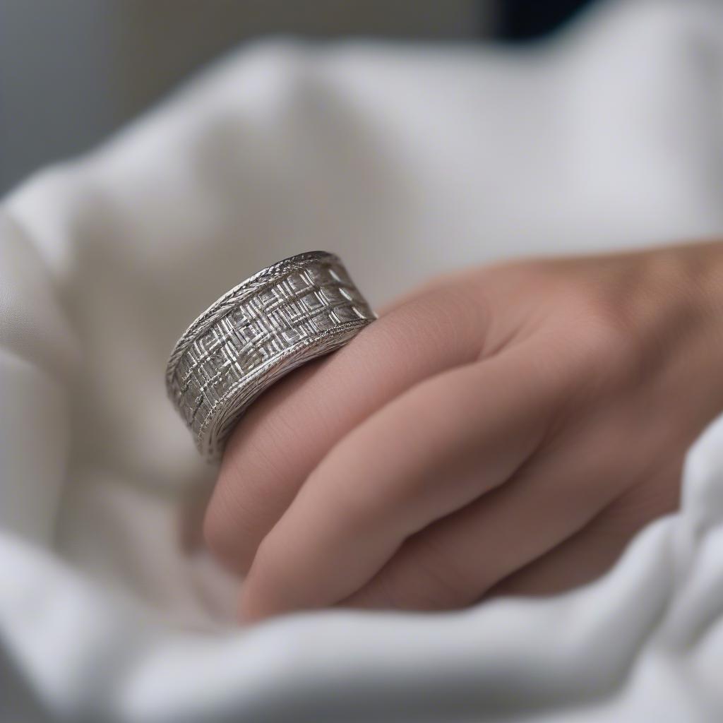 Cleaning a white gold basket weave ring with a soft cloth and soapy water.