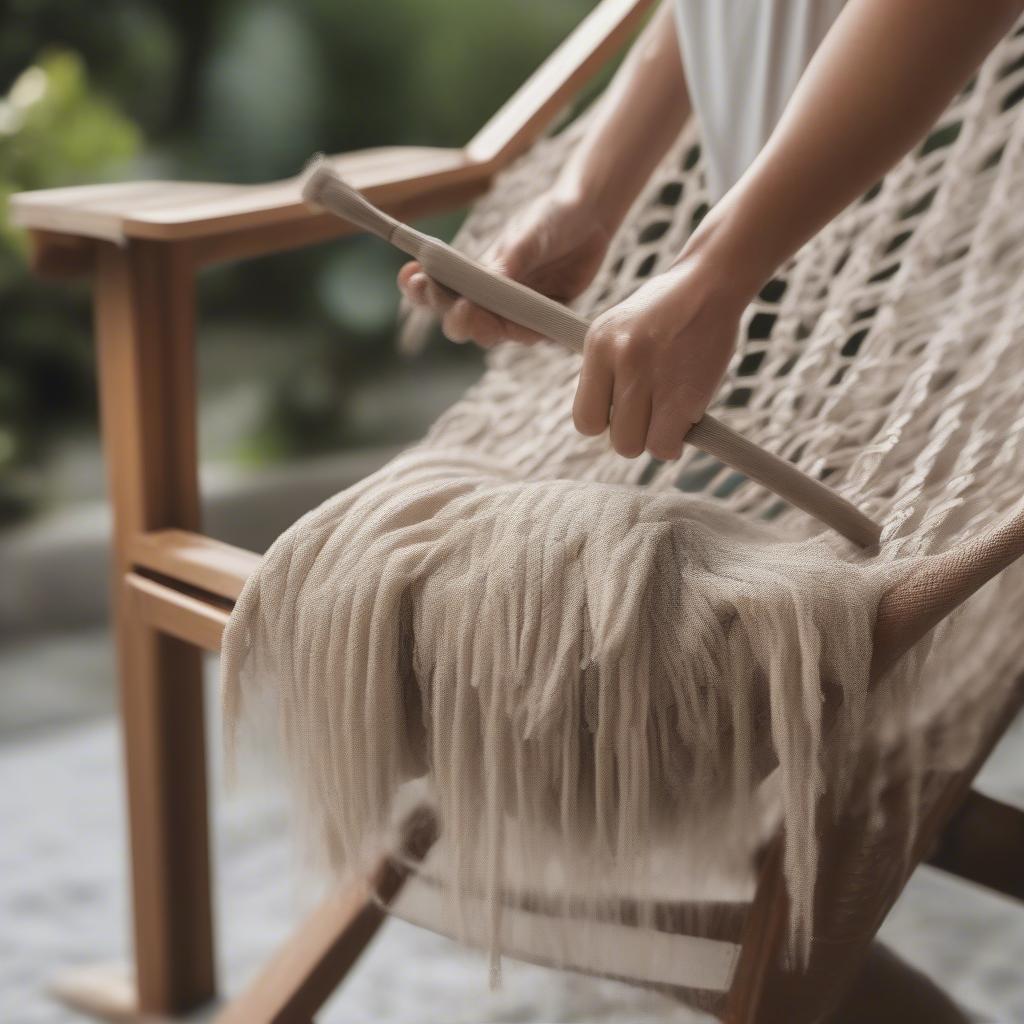 Cleaning an outdoor hammock weave chair using a soft brush and mild soapy water.