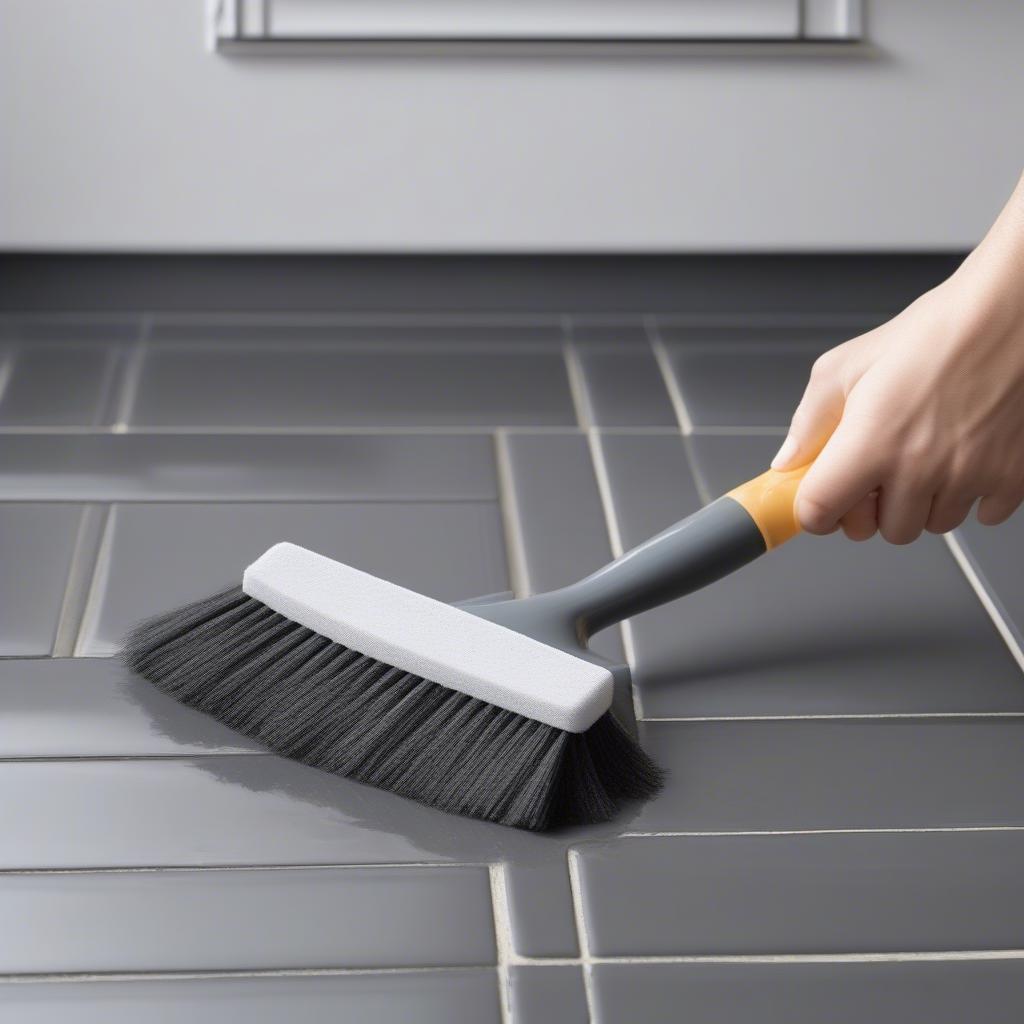 Cleaning black grout with a soft brush and pH-neutral cleaner.