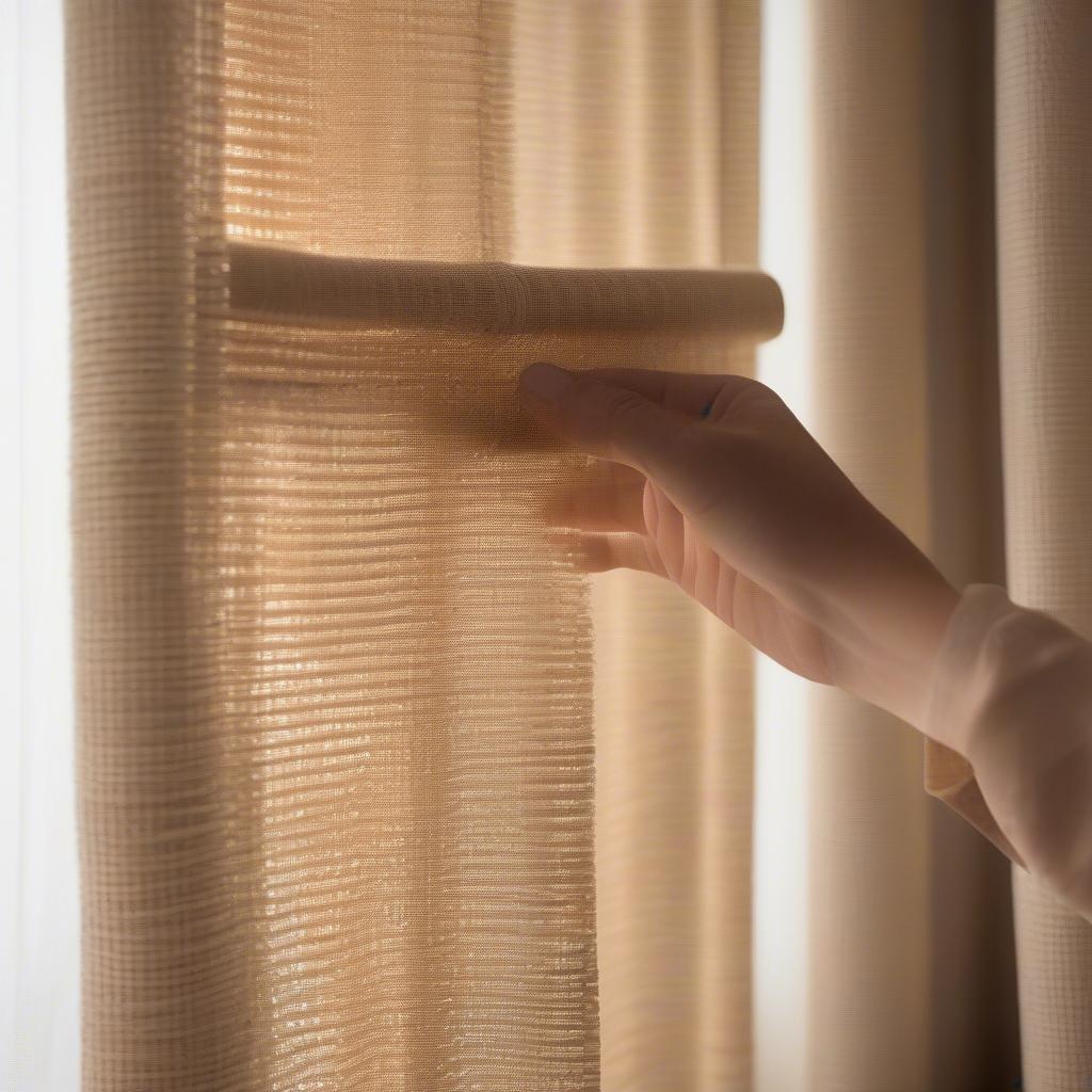 Demonstrating how to clean a parker basket weave curtain with a soft brush.