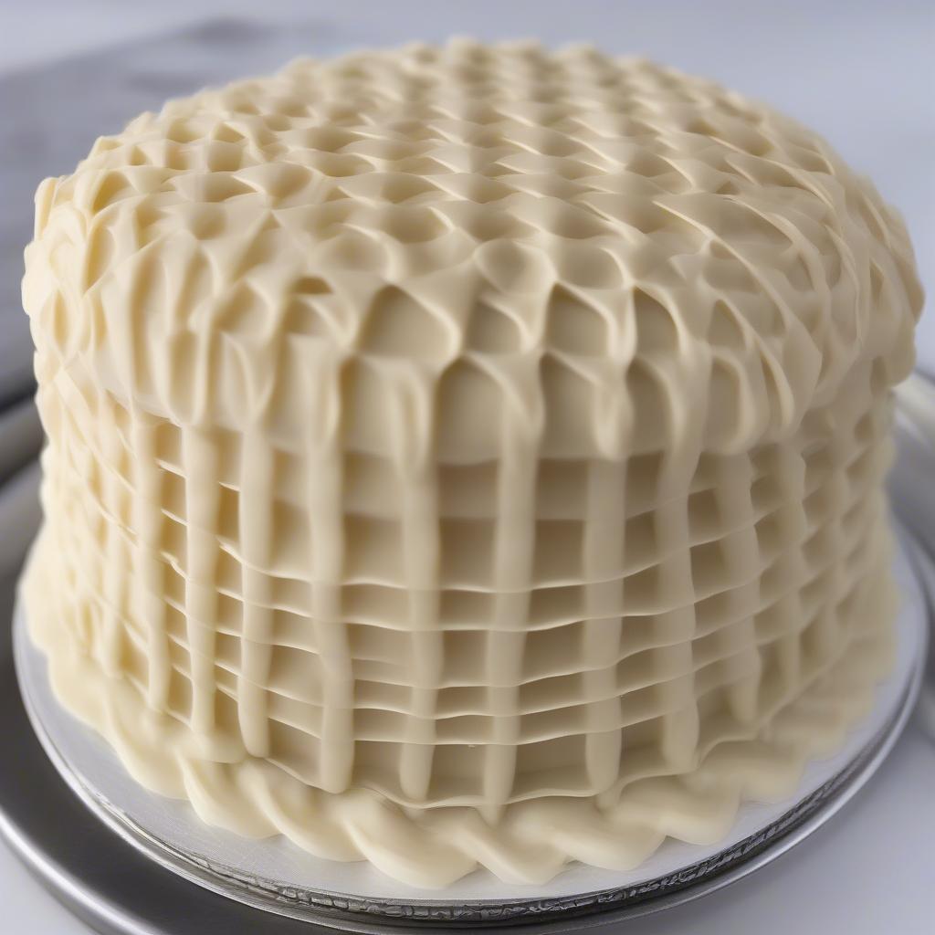 Close-up screenshot of a basket weave cake video, showing the icing being piped.