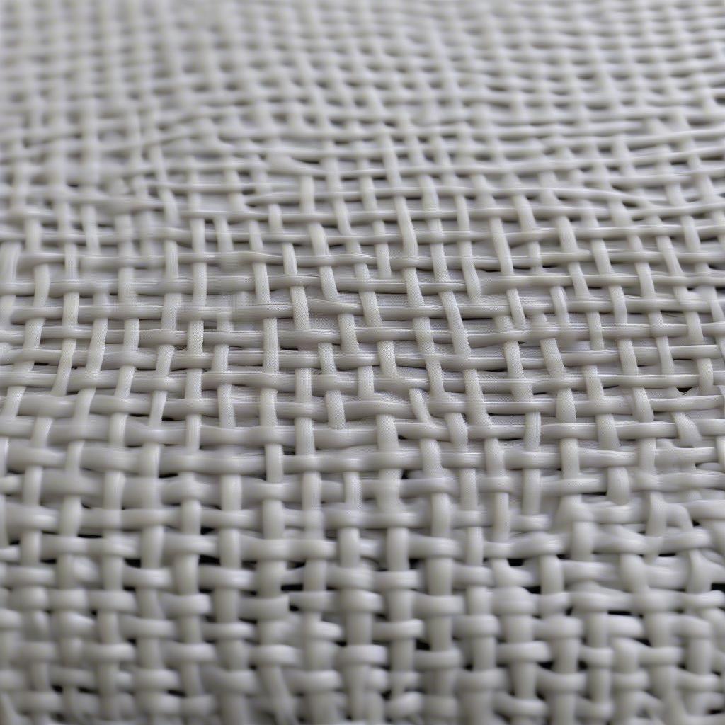 Close-up view of the woven texture of a plastic planting bag, highlighting its breathability and drainage capabilities.