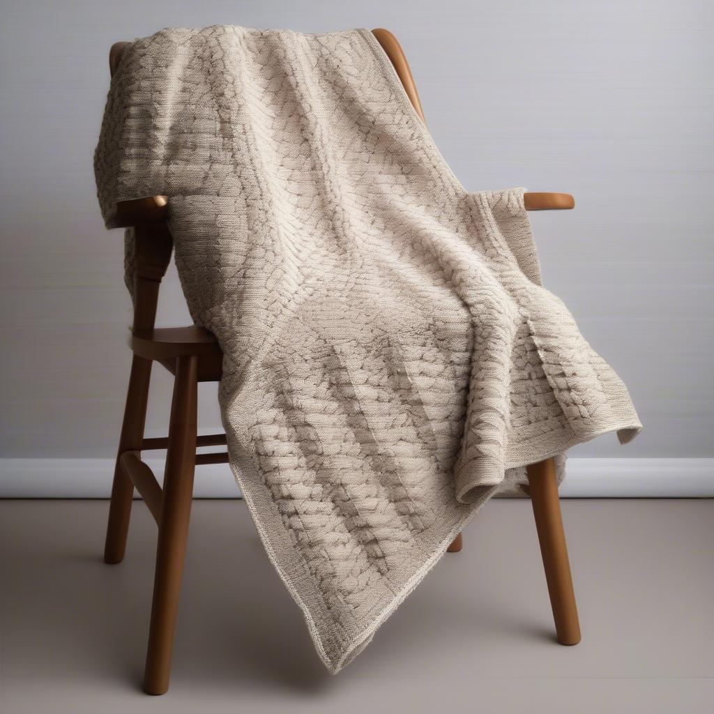 A completed crochet basket weave blanket, showcasing the beautiful texture and the potential for creating cozy and stylish home decor items.