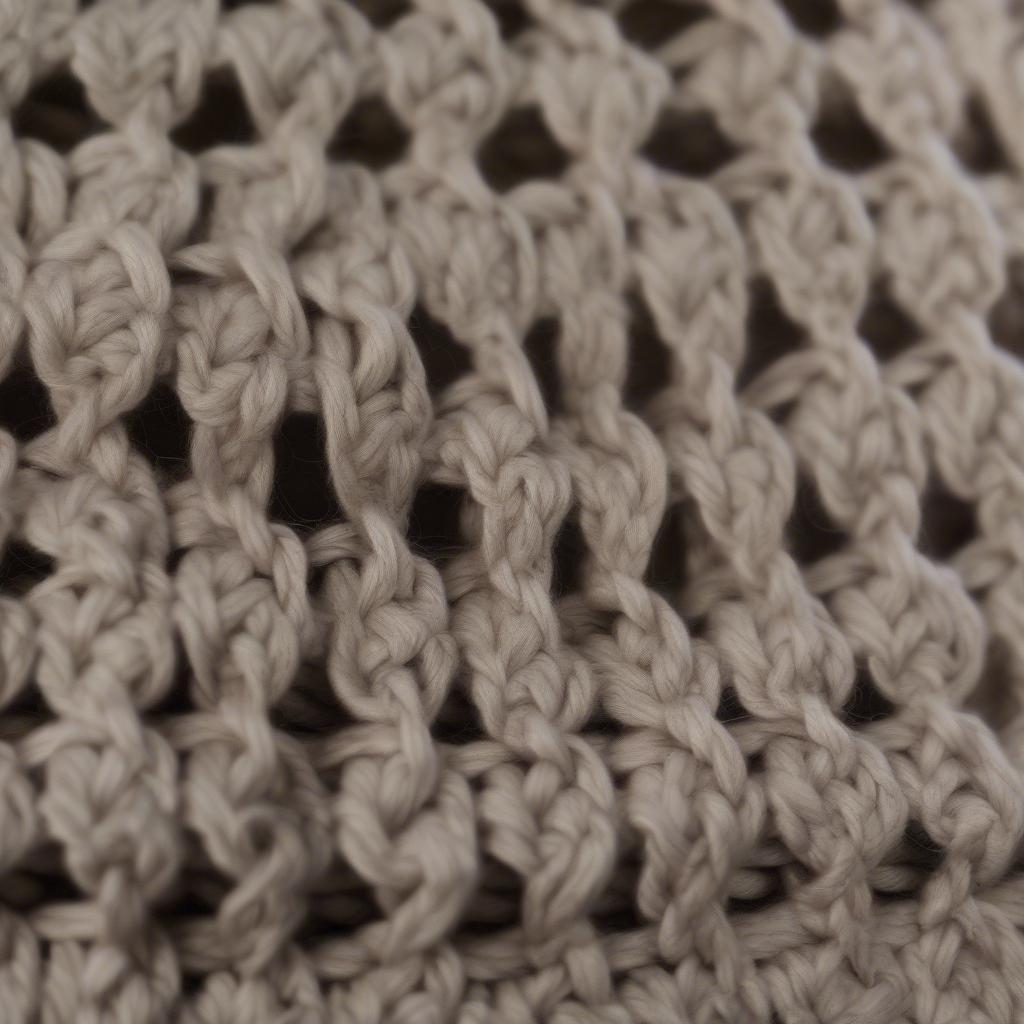 Close-up of a finished crochet basket weave slouchy hat, showcasing the intricate stitch detail and soft texture.