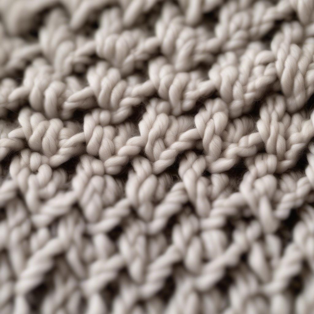 Close-up view of the crochet basket weave stitch, showing the intricate texture and the interplay of front and back post stitches.