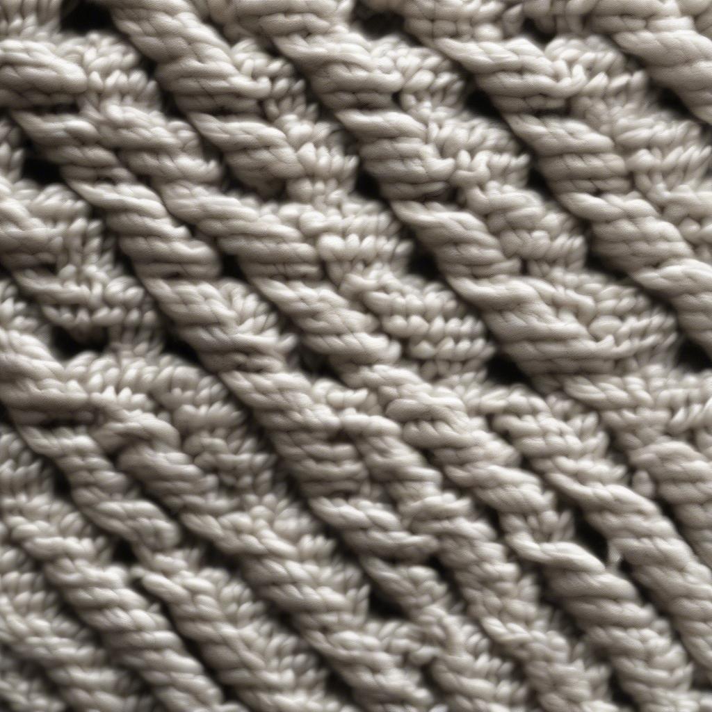 Close-up view of the diagonal basket weave cable stitch showing its intricate texture and pattern