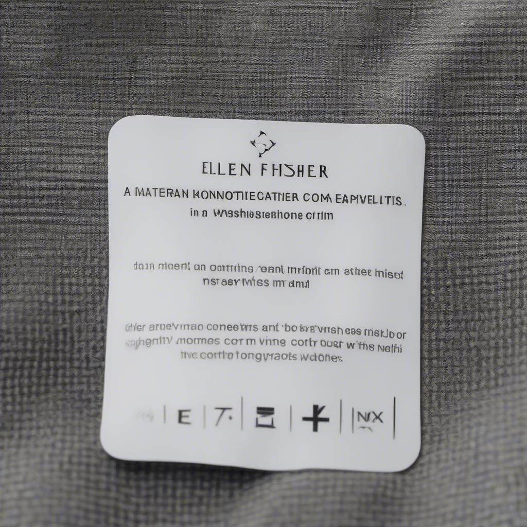 Care instructions tag attached to an Eileen Fisher basket weave coat.