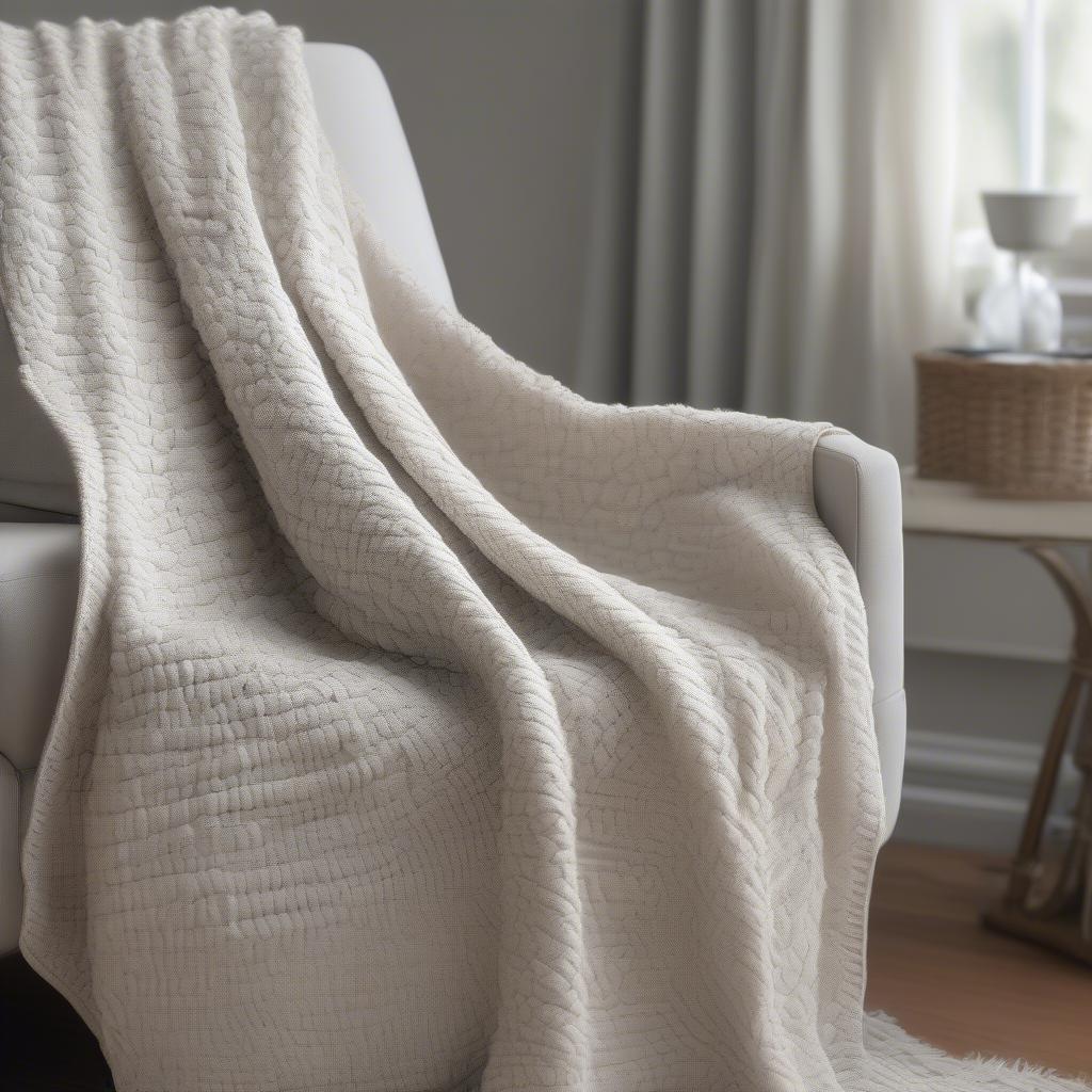 A completed basket weave blanket draped over a chair, showcasing its cozy texture and finished look.