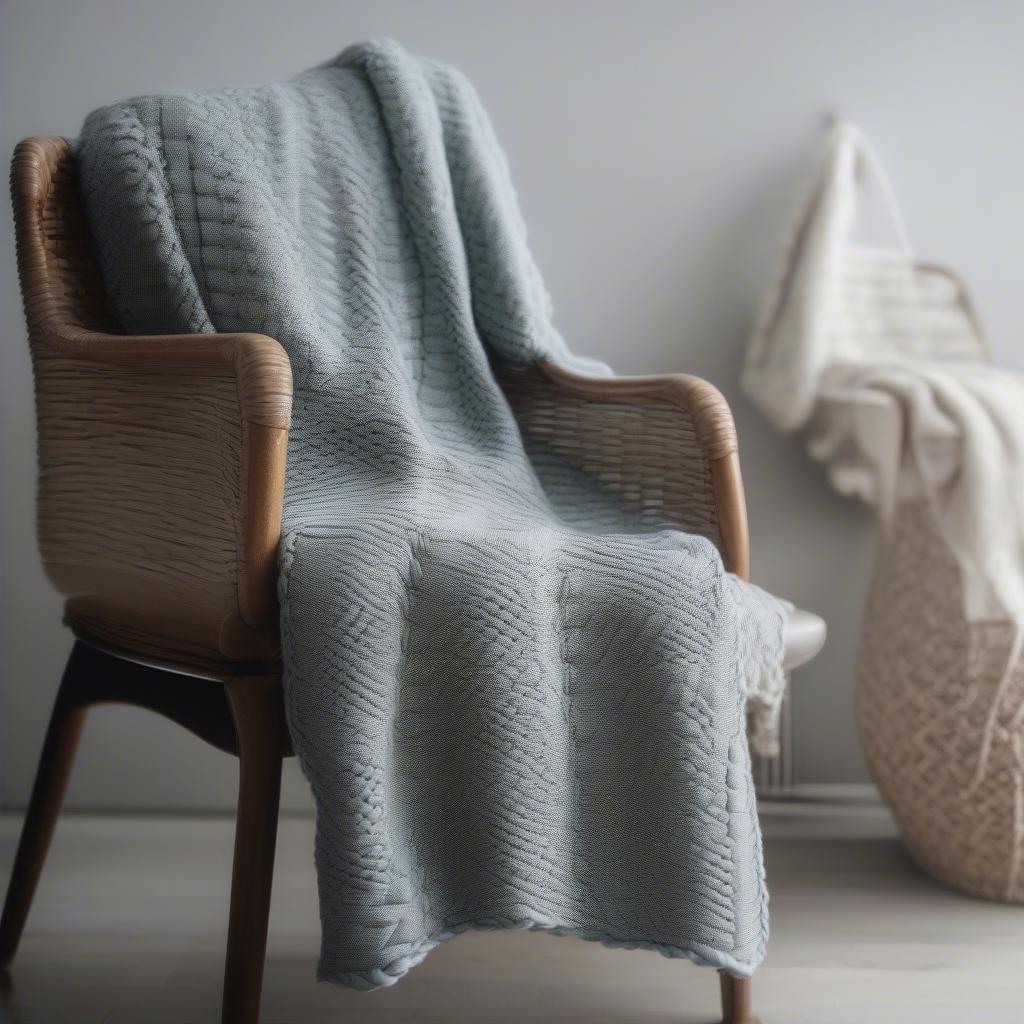 A completed knitted blanket showcasing the basket weave pattern.