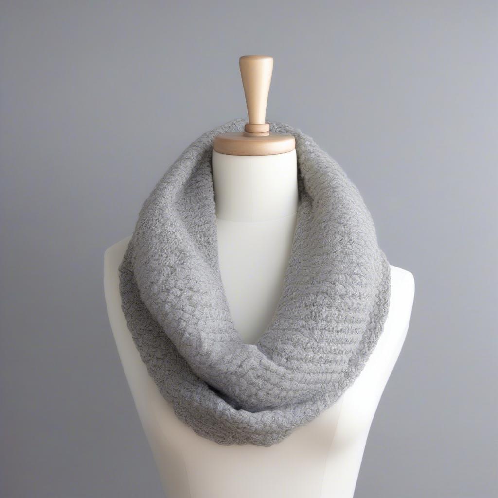 A completed basket weave infinity scarf draped over a mannequin