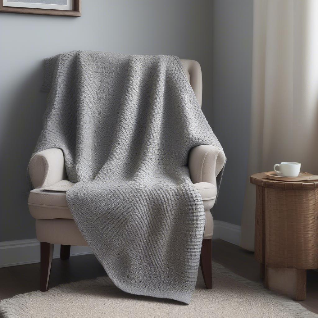 Completed basket weave lap blanket draped over a chair