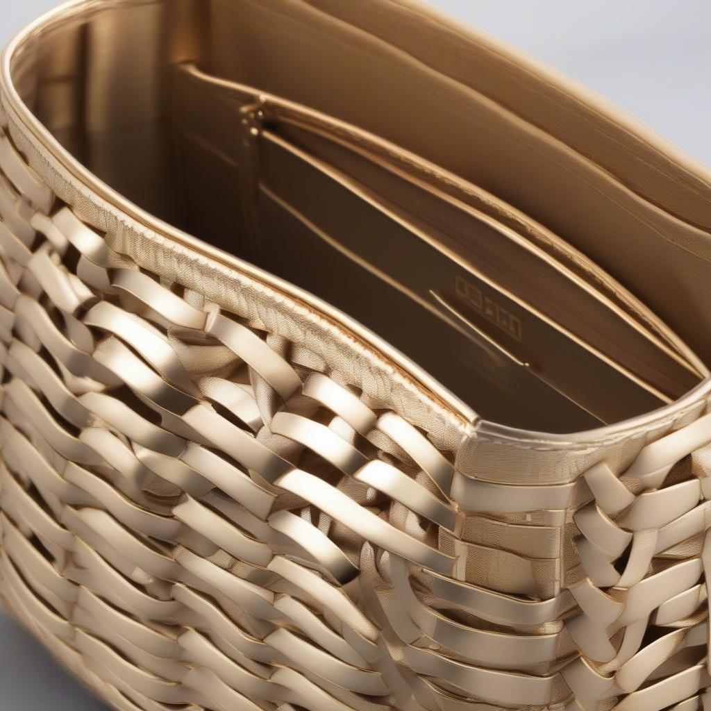 Close-up of a gold basket weave clutch showcasing the intricate weaving details and luxurious gold finish