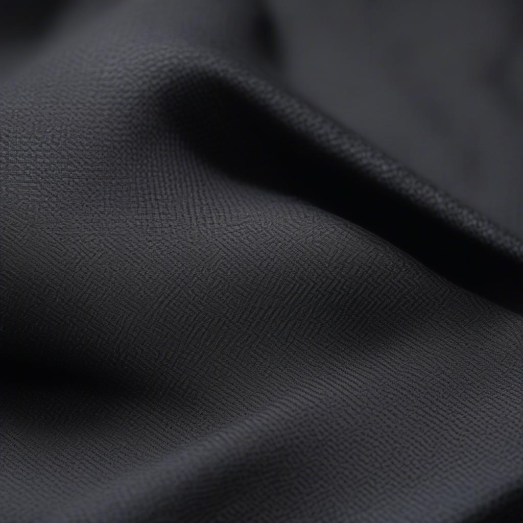 Close-up of grey basket weave charcoal sportcoat fabric