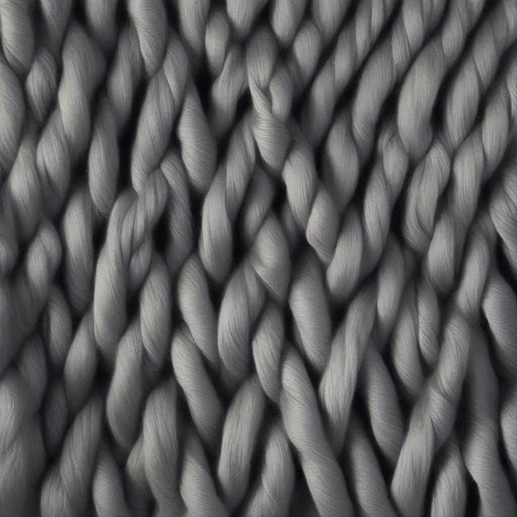 Close-up of the yarn texture of the grey evolution pullover, showcasing its quality