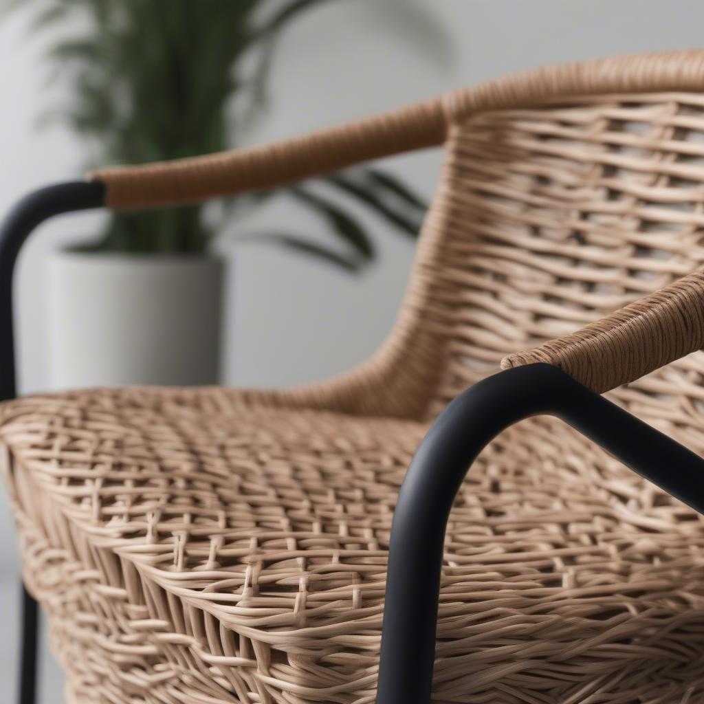 Close-up of the wicker weave and metal frame of a Hampton Bay folding patio chair