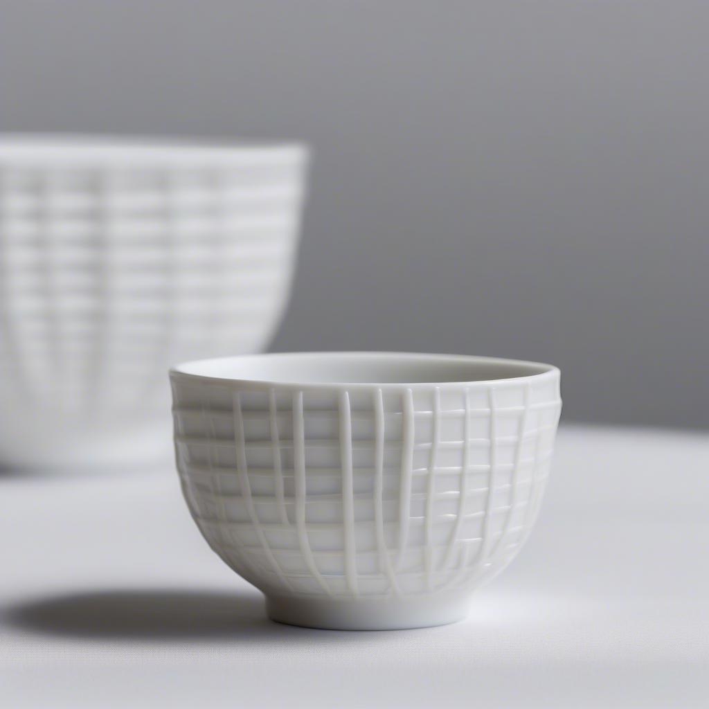 Close-up of a Japanese porcelain teacup with a delicate basket weave imprint